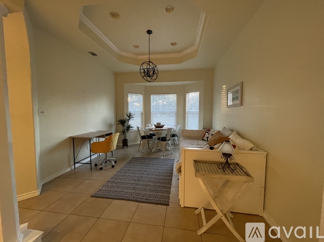 A living room with a dining table and chairs.