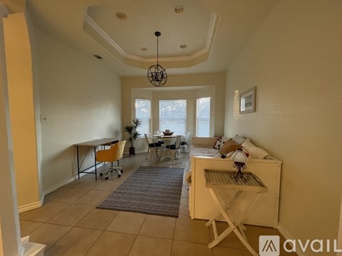 A living room with a dining table and chairs.