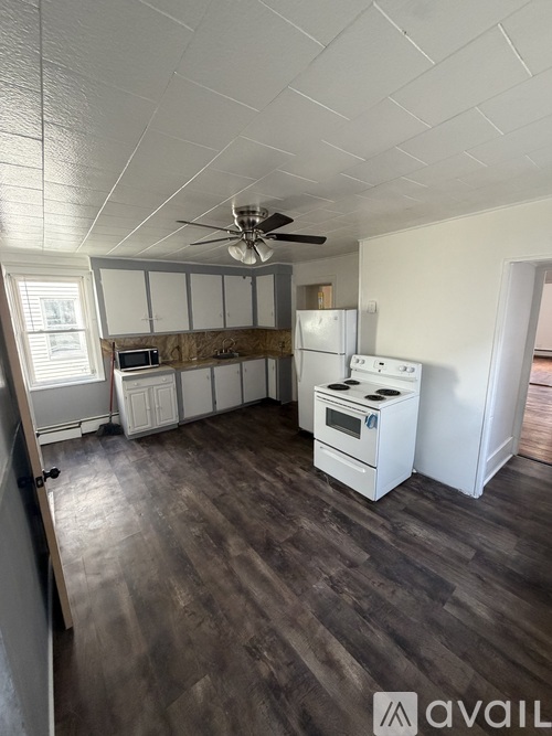 A kitchen with a white fridge, a stove, and a microwave.