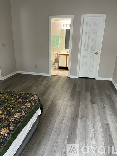 A bedroom with a bed and a door.