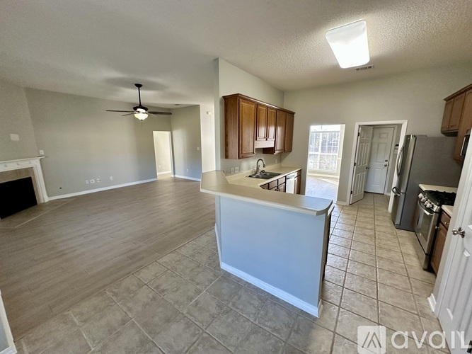 A kitchen with a white island in the middle of the room.