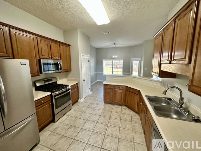 A kitchen with wooden cabinets and a white refrigerator.