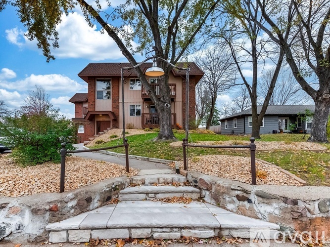 A house with a stone pathway leading to the front door.