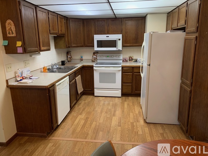 A kitchen with wooden cabinets and a white refrigerator.