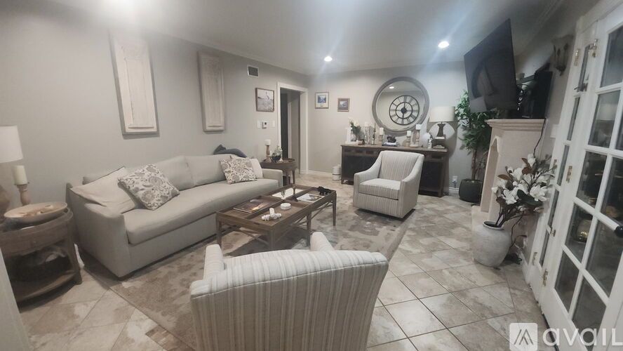 A living room with a couch, armchair, and coffee table.