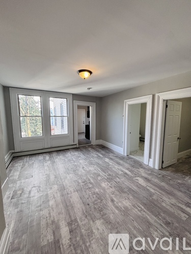 A room with grey flooring and white walls.