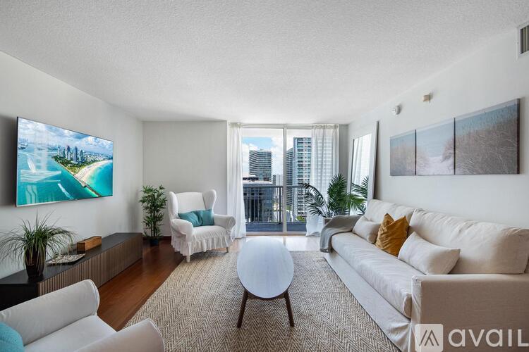 A living room with a large painting on the wall and a view of a city skyline.