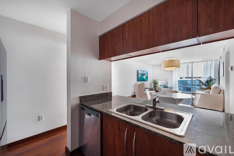 A kitchen with a stainless steel dishwasher and sink.