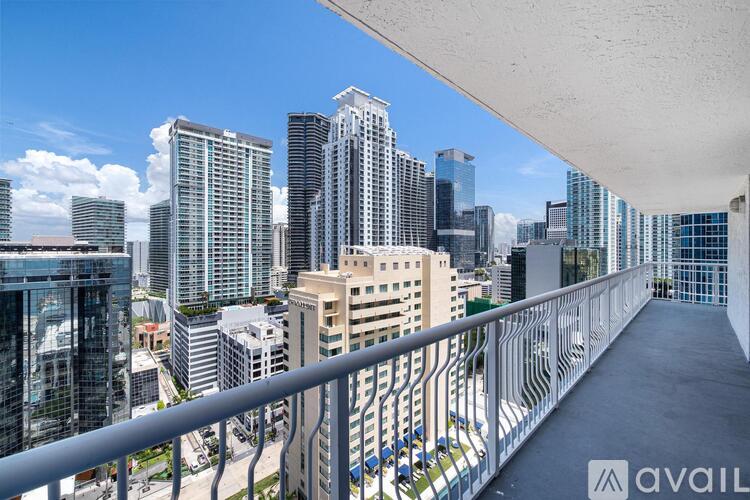 A balcony overlooks a cityscape with tall buildings.
