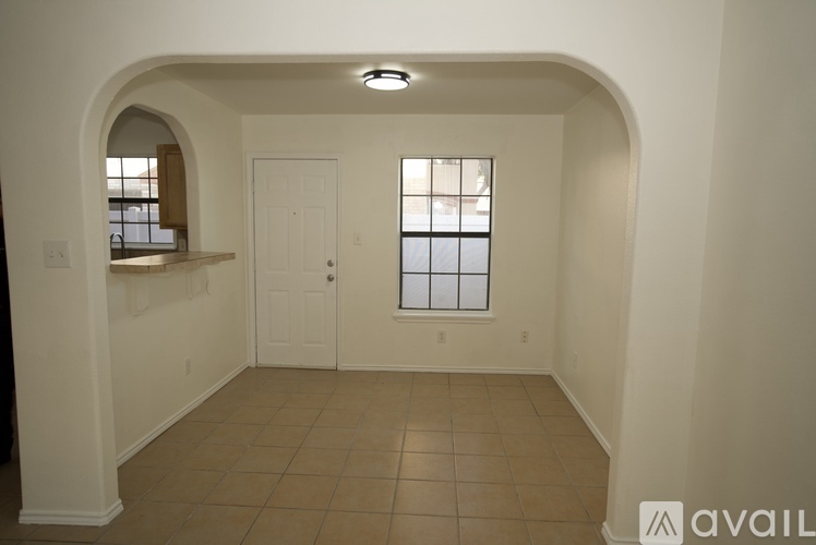 A room with a window and a door is available for rent.