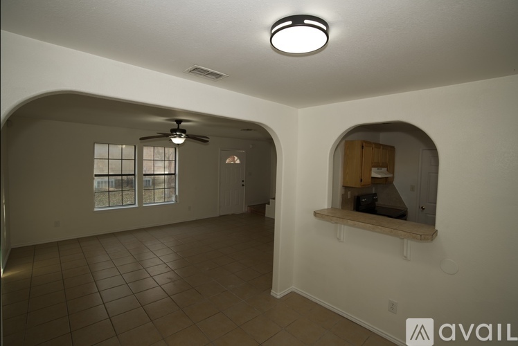 A room with a fan and a window.