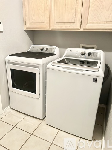 A white oven and dishwasher in a kitchen.