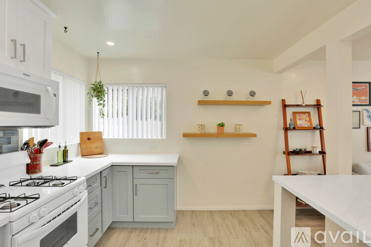A kitchen with white appliances and a white counter top.