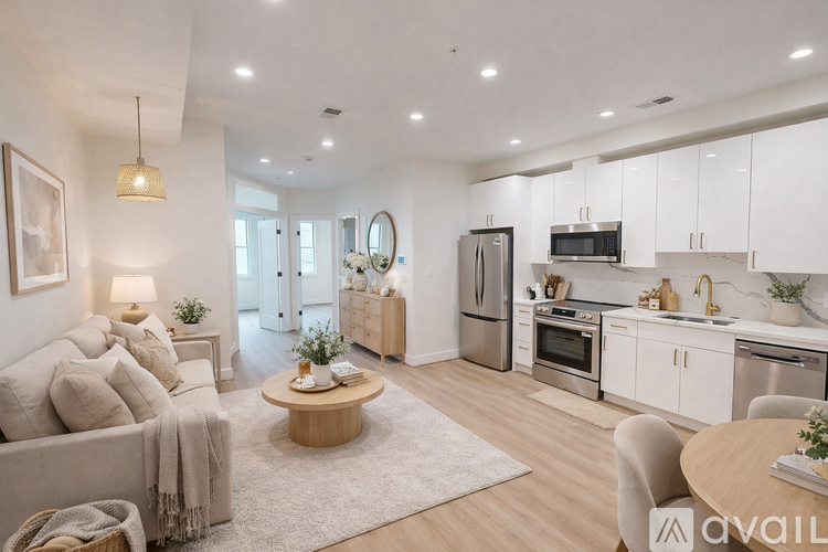A modern kitchen with white cabinets and stainless steel appliances.