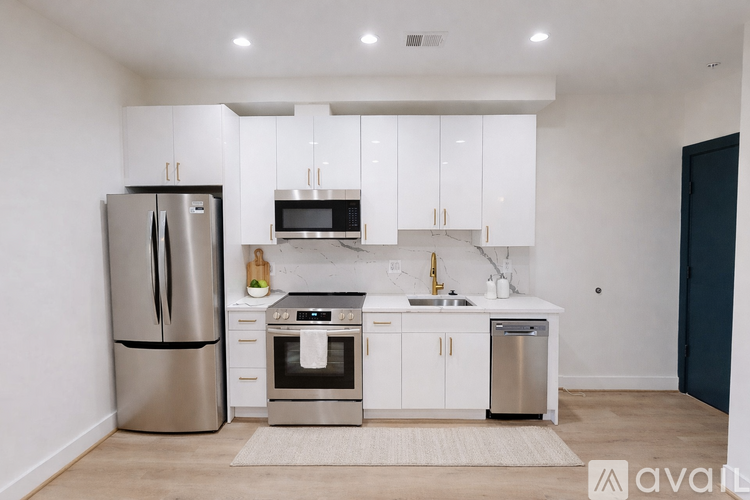 A kitchen with white cabinets and stainless steel appliances.