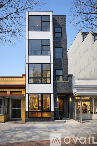 A tall building with a yellow storefront at the bottom.