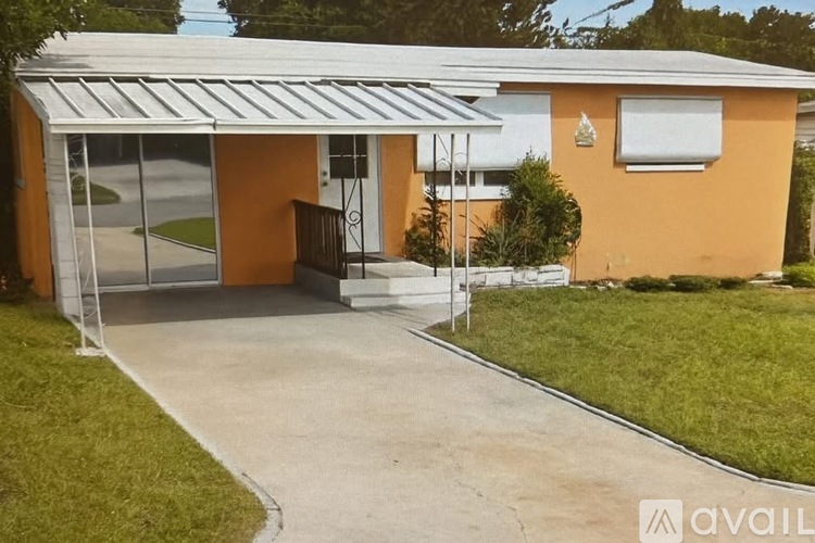 A house with a white roof and orange walls is available for rent.