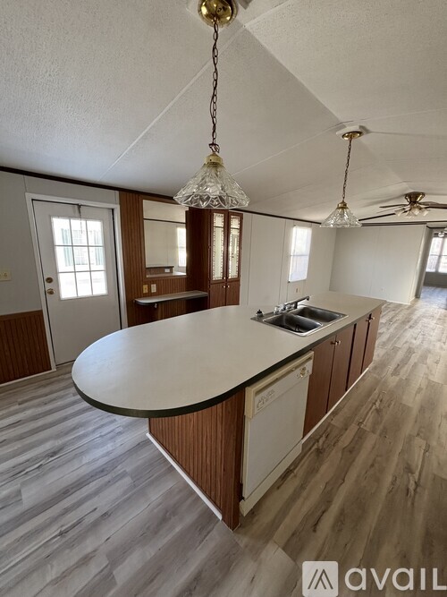 A kitchen with a large island in the middle of the room.