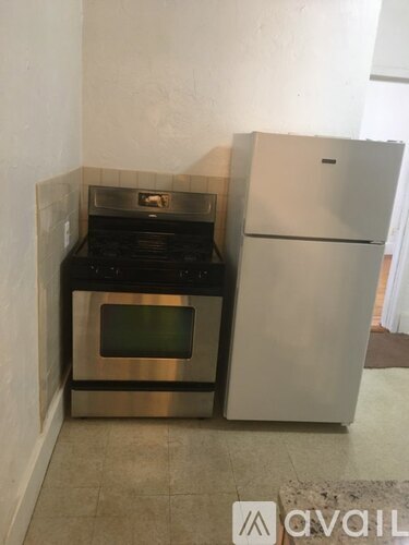 A stainless steel oven and fridge in a kitchen.