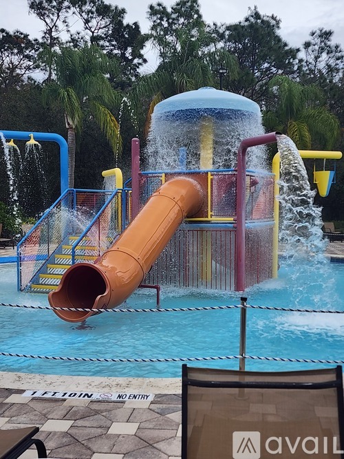 A water slide in a pool with a sign that says "NO ENTRY".