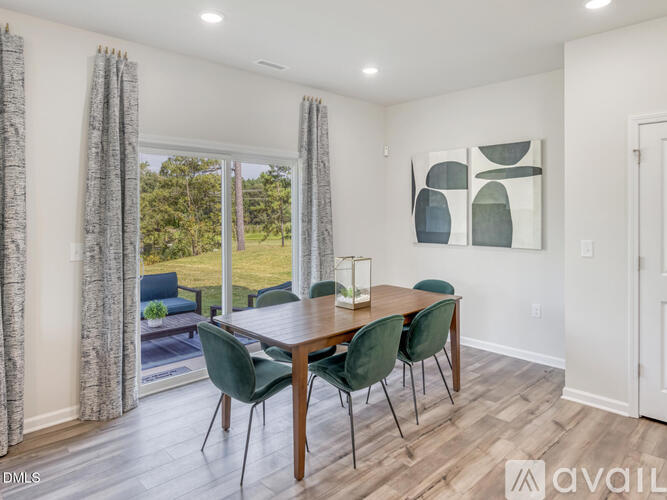 A dining room with a wooden table and chairs.