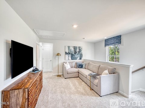 A living room with a large couch and a television.