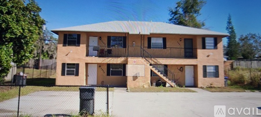 A two-story house with a balcony on the second floor.