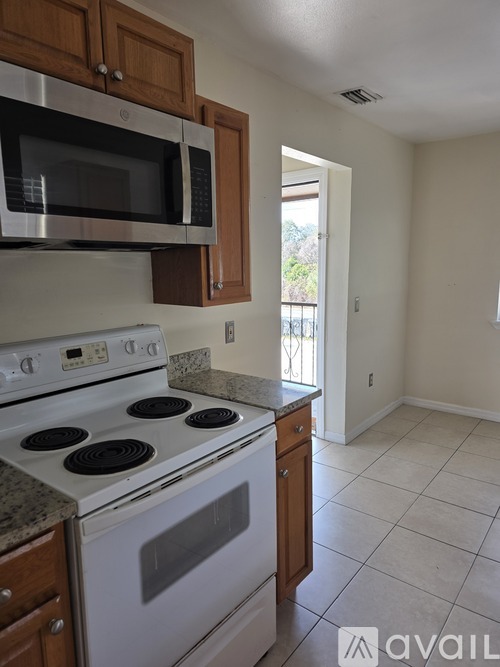 A kitchen with wooden cabinets and a countertop.
