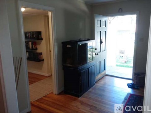 A living room with a television and a bookshelf.