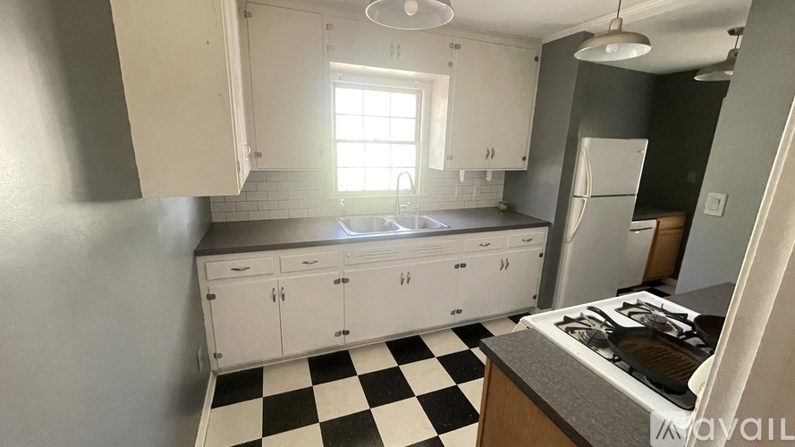 A kitchen with a black and white checkered floor.