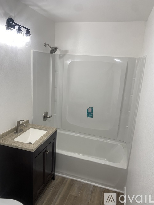 A bathroom with a sink, toilet, and shower.
