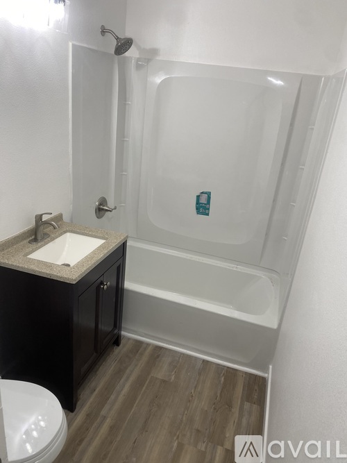 A bathroom with a sink, toilet and bathtub.