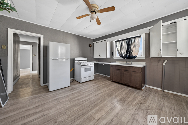 A kitchen with a white refrigerator, a white oven, and a white dishwasher.