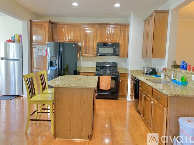A kitchen with wooden cabinets and a granite countertop.