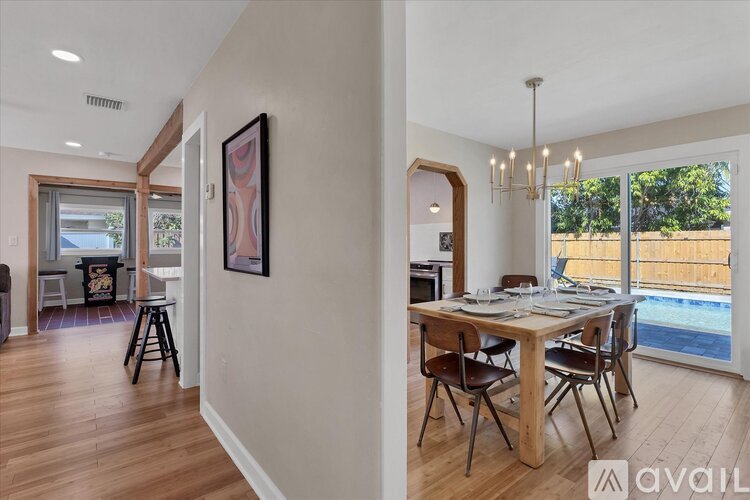 A dining room with a wooden table and chairs.
