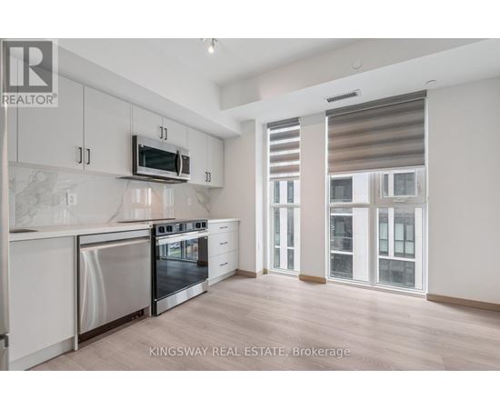 A kitchen with a stainless steel oven and microwave.