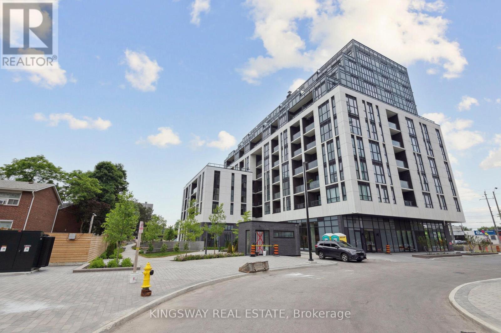 A modern building with the sign Kingsway Real Estate Brokerage on it.
