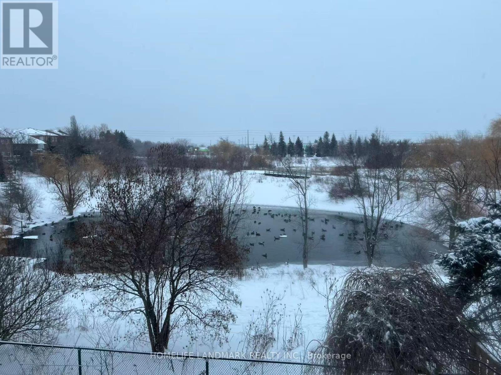 A snowy landscape with a fence and trees.