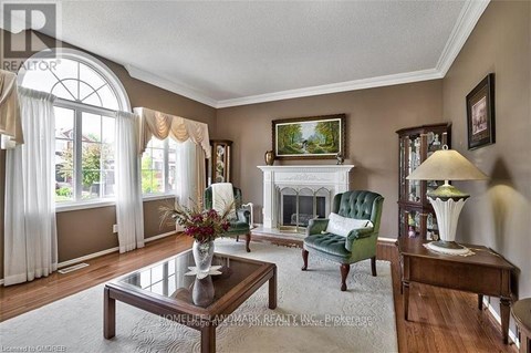 A living room with a fireplace and a painting on the wall.