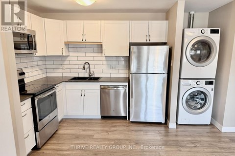 A kitchen with white cabinets and stainless steel appliances.