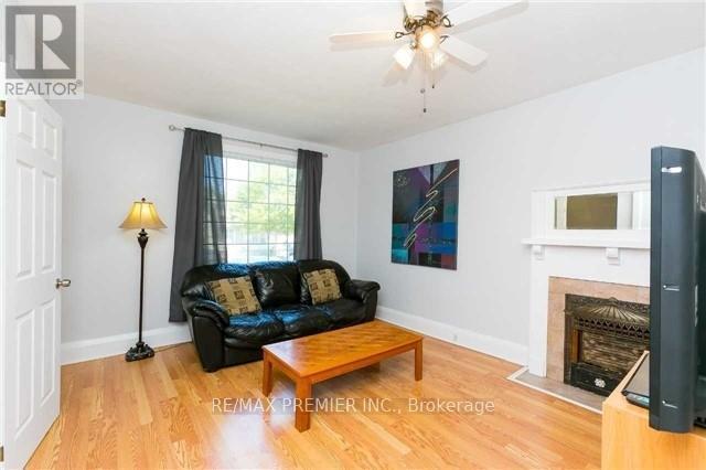 A living room with a black couch and a fireplace.