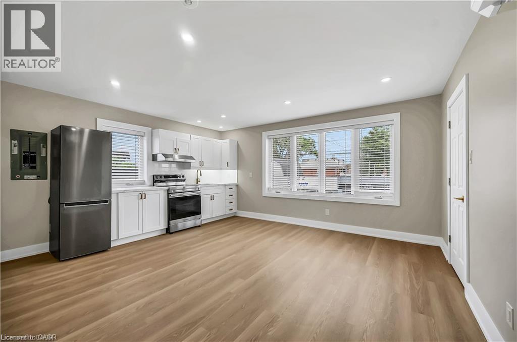 A well-lit kitchen with wooden floors and modern appliances.