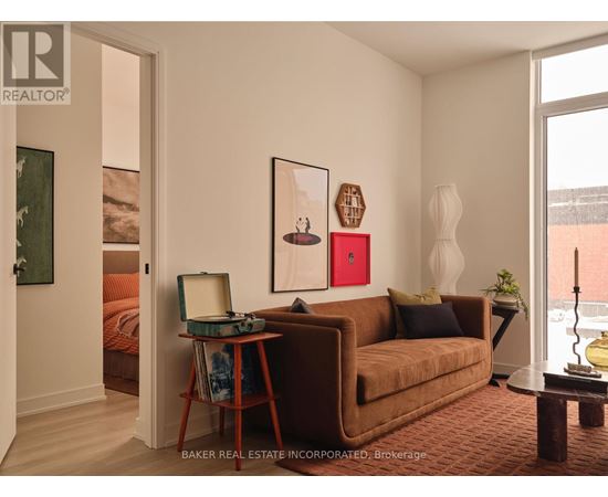 A modern living room with green chairs and a coffee table.