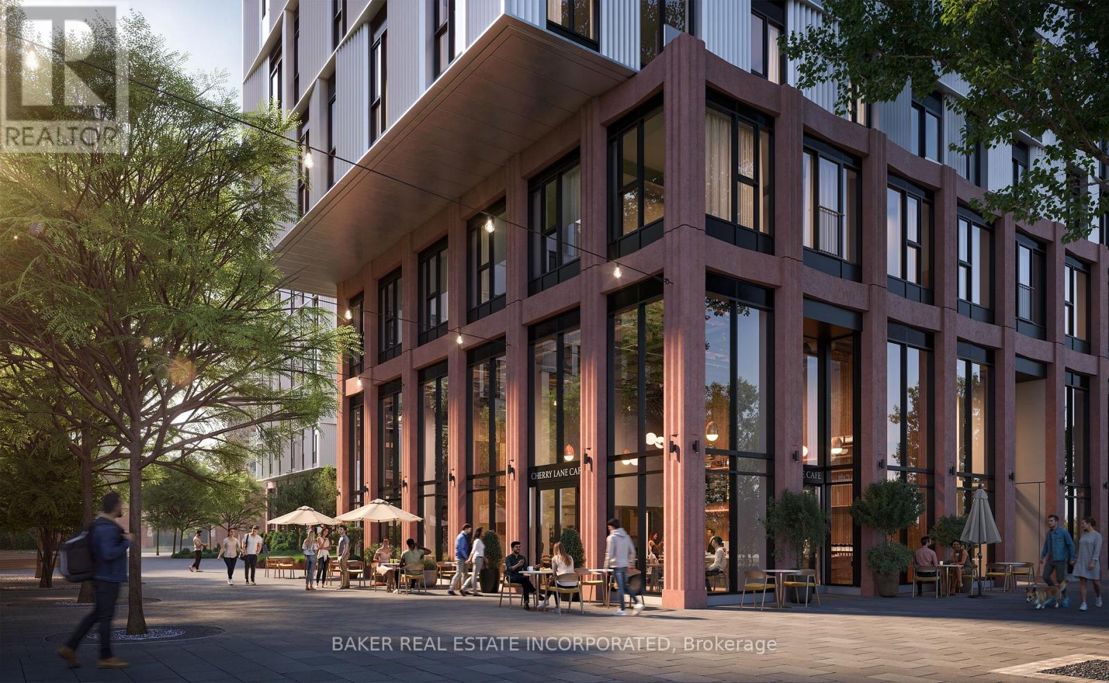 A modern building with a lot of windows and people walking around outside.