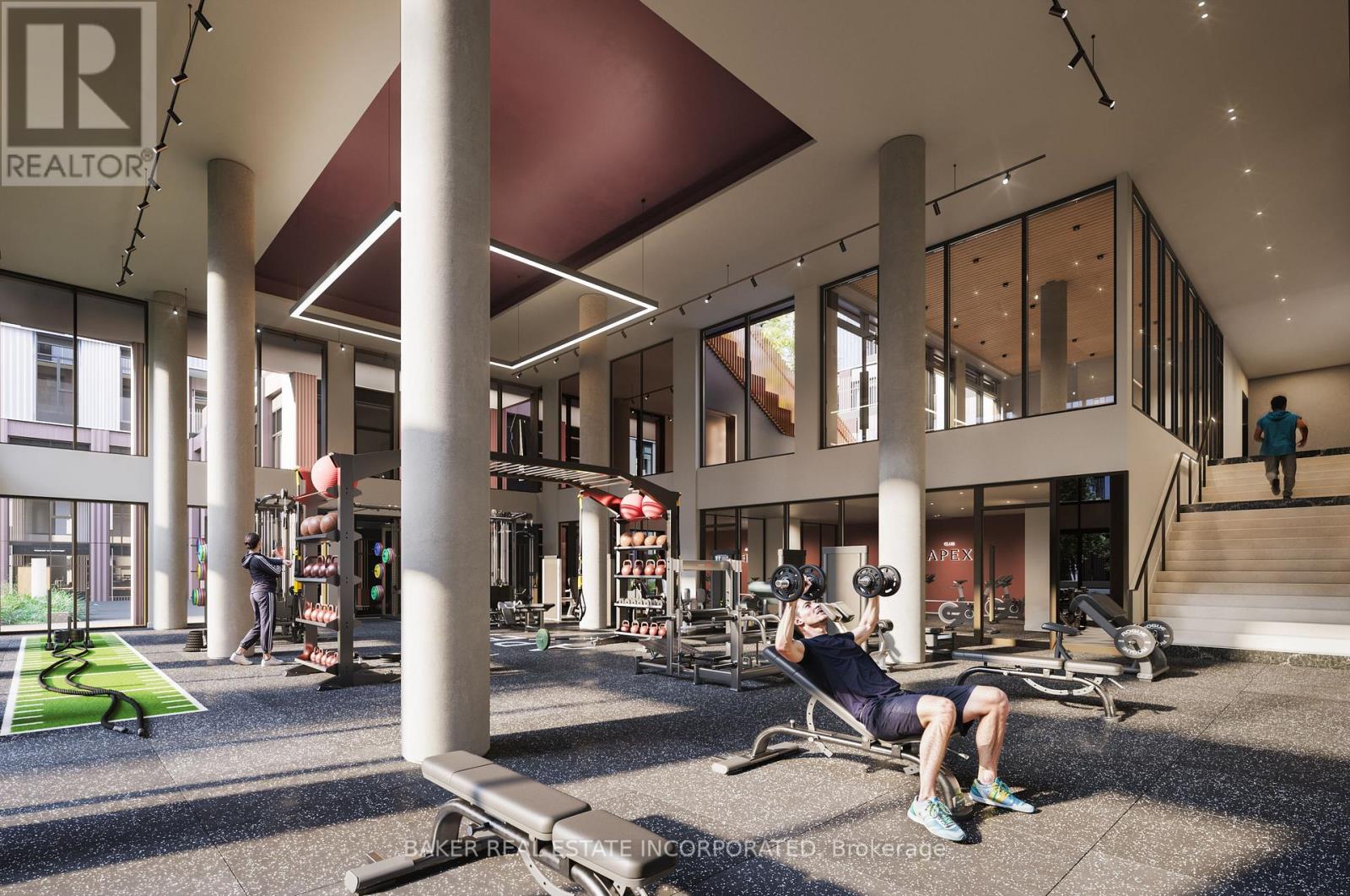 A gym with a man working out on a rowing machine.