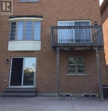 A building with a balcony and a window is for sale.