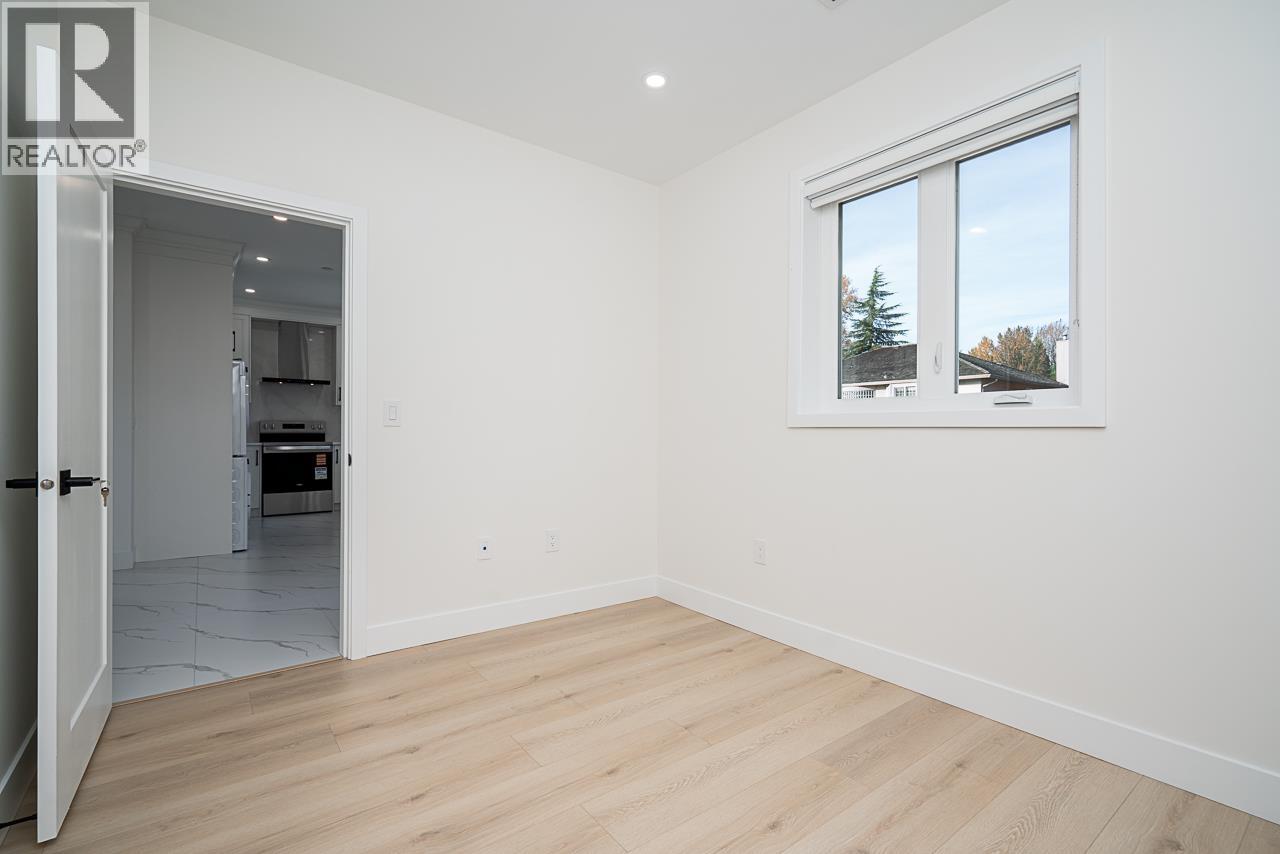 A room with a window showing trees outside.