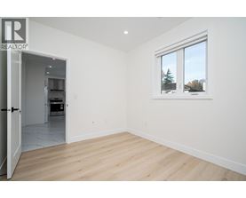 A room with a window showing trees outside.