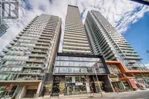 Two tall buildings with balconies are in the foreground.