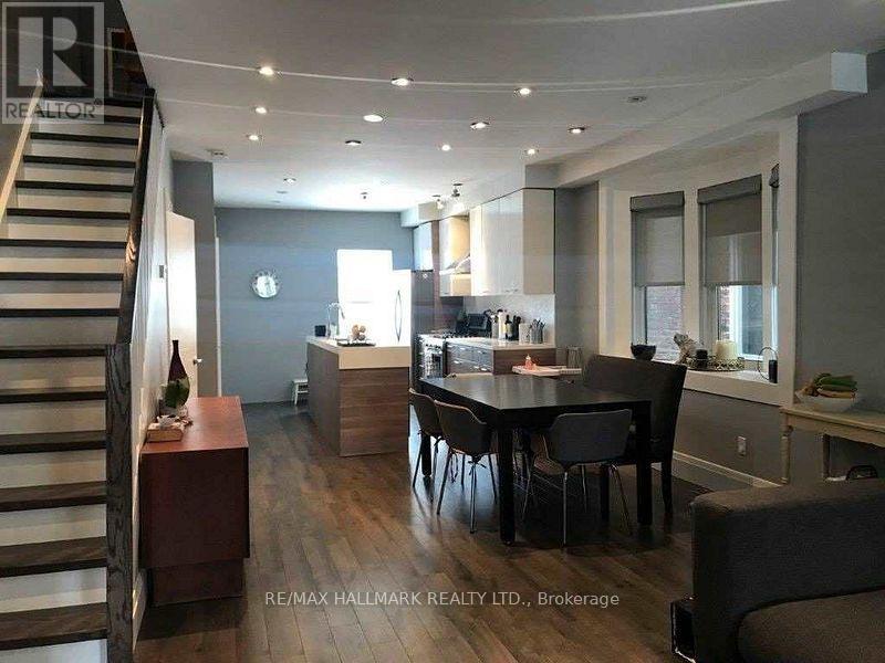 A modern kitchen with a dining table and chairs.